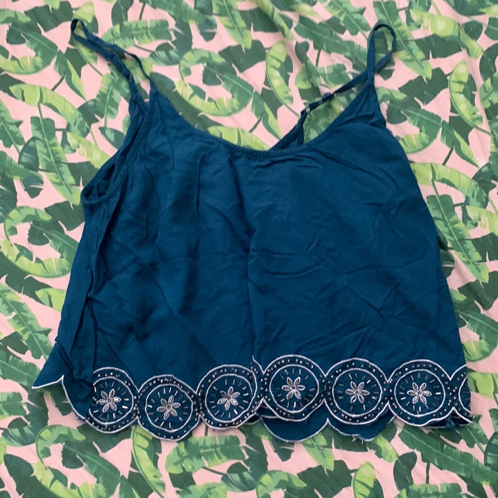 Small cute crop top with a beaded pattern on the bottom